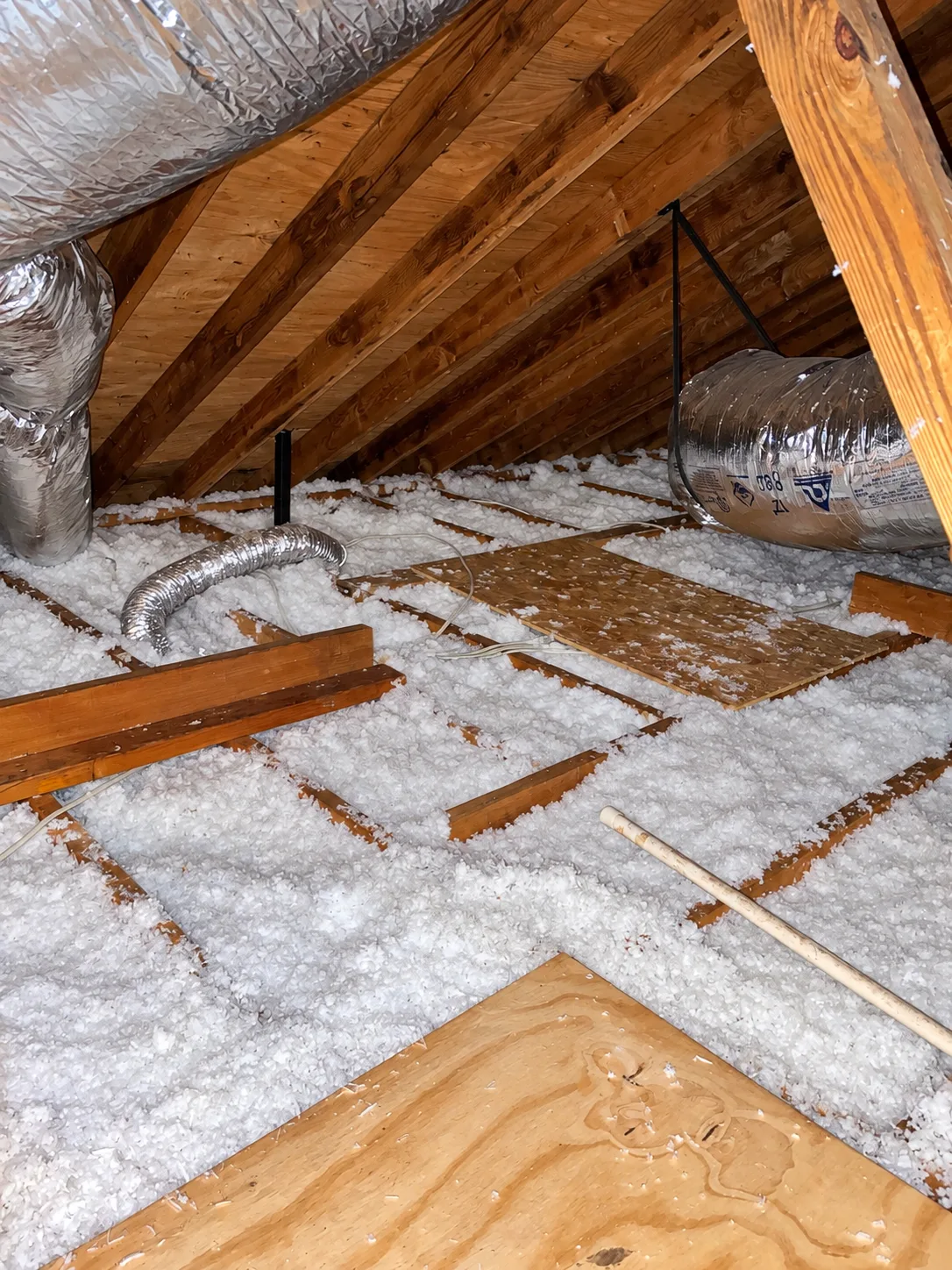 Attic with loose-fill insulation, ductwork and walk boards