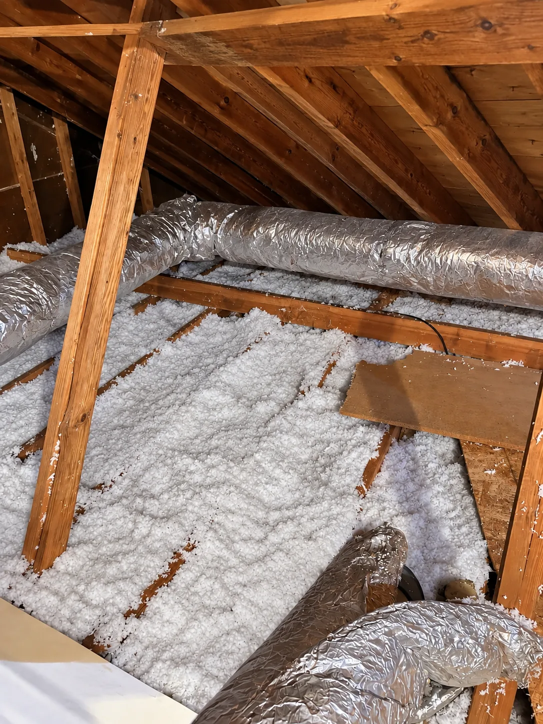 Blown-in insulation across attic joists